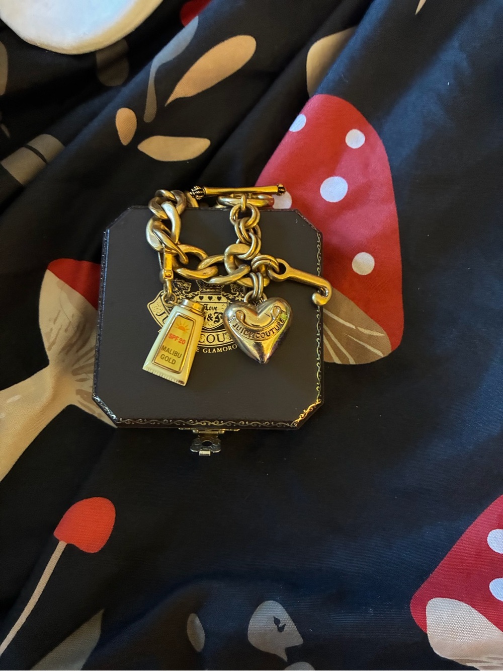 Juicy Couture Gold-Tone Charm Bracelet with Heart and Sun tan lotion Charms